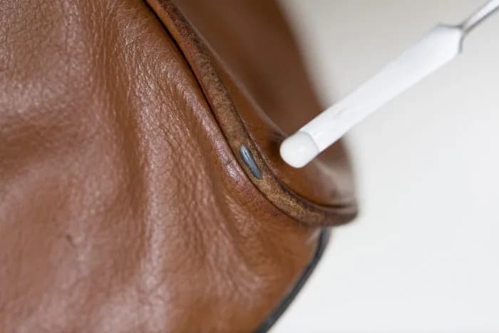 Professional repair of scuffed leather handbag corners